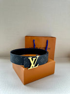 Navy monogram belt with gold-tone LV buckle on folded strap