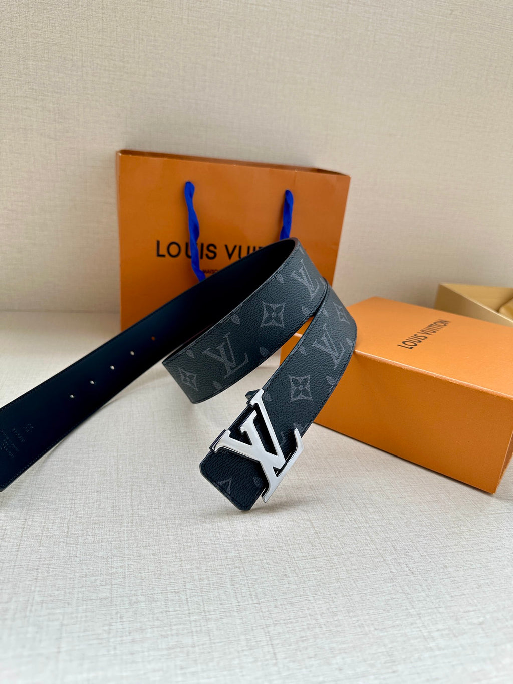 Navy monogram belt with large LV buckle, folded over