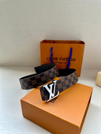 Louis Vuitton damier belt with gold-tone LV buckle and dark interior, laid on box