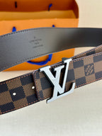 Louis Vuitton belt detail showing dark damier pattern and gold-tone LV logo buckle