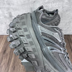 Gray Balenciaga lace-up sneaker side view with mesh panels and deep lug outsole