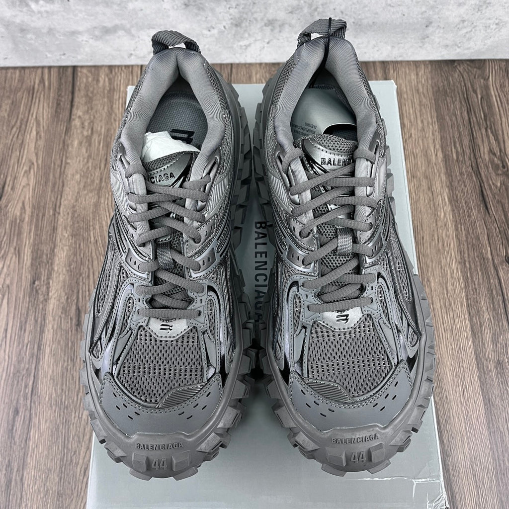 Pair of gray Balenciaga sneakers with printed interior tag and lace-up openings