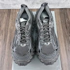 Pair of gray Balenciaga sneakers with printed interior tag and lace-up openings