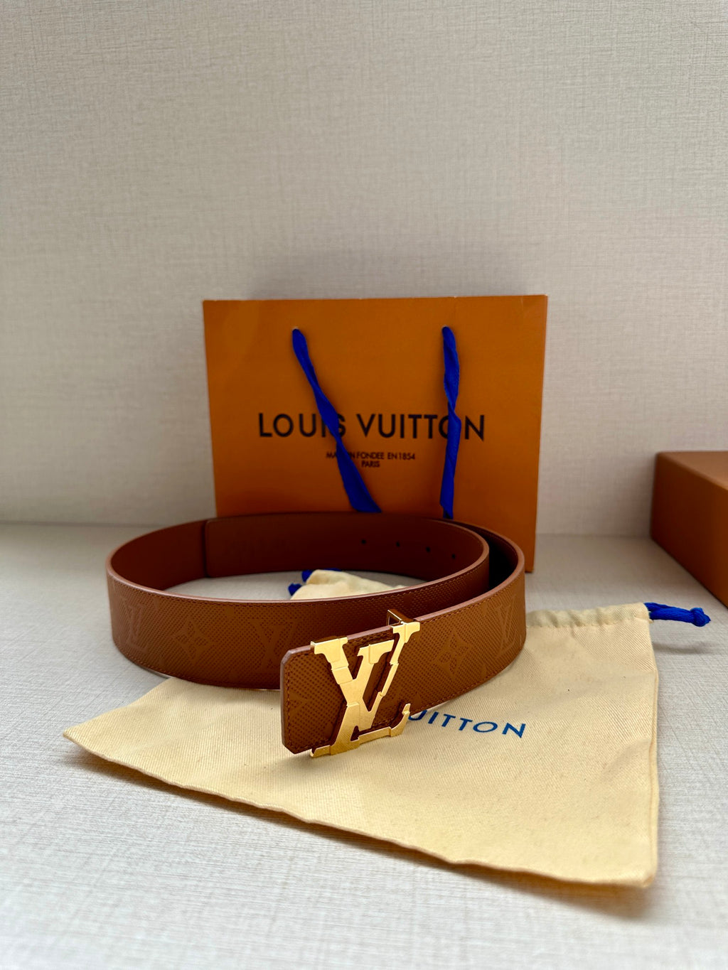 Tan monogram leather belt, silver buckle, with dust bag and Louis Vuitton box