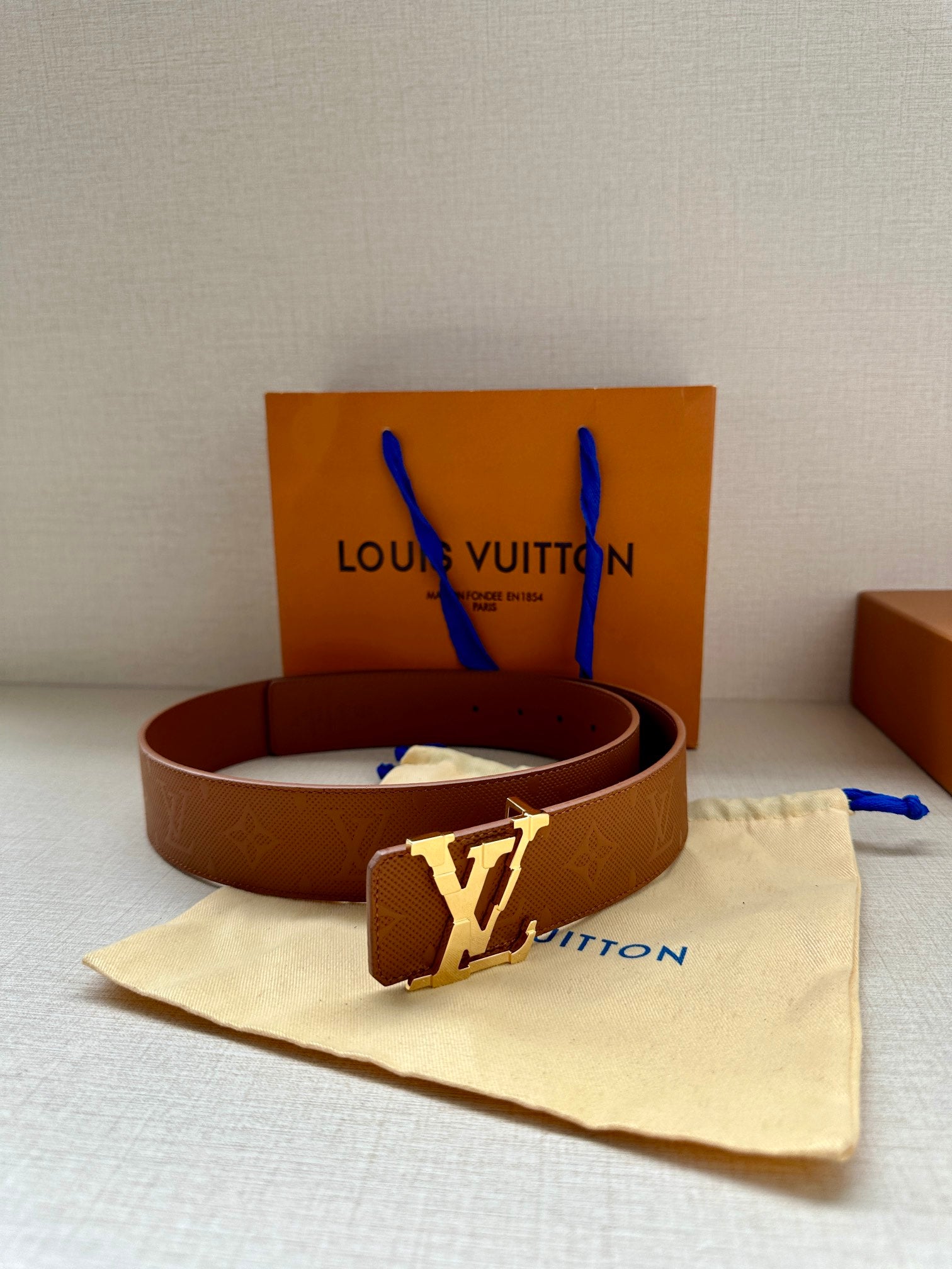 Tan monogram leather belt, silver buckle, with dust bag and Louis Vuitton box