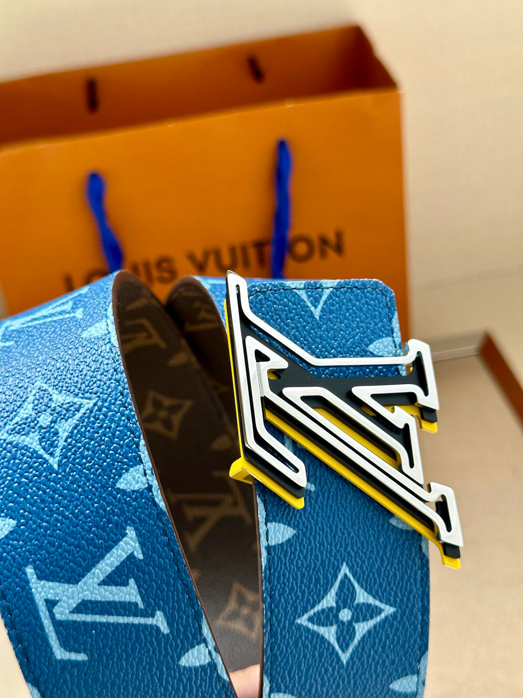 Louis Vuitton belt buckle with blue monogram strap and brown leather backing