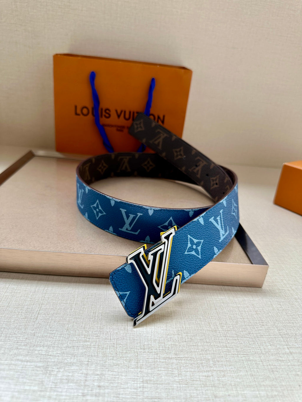 Louis Vuitton blue monogram belt with silver LV buckle, front view