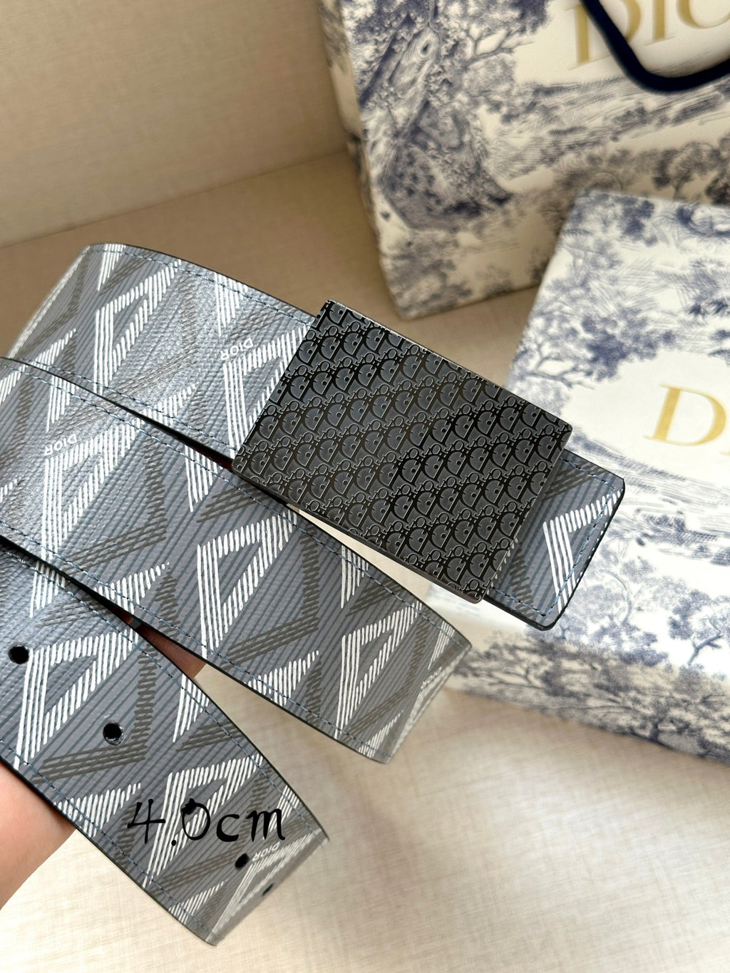 Dior belt with black textured buckle and patterned gray-blue strap, 4.0cm width