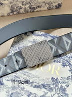 Dior belt close-up with blue leather strap and gray jacquard logo panel