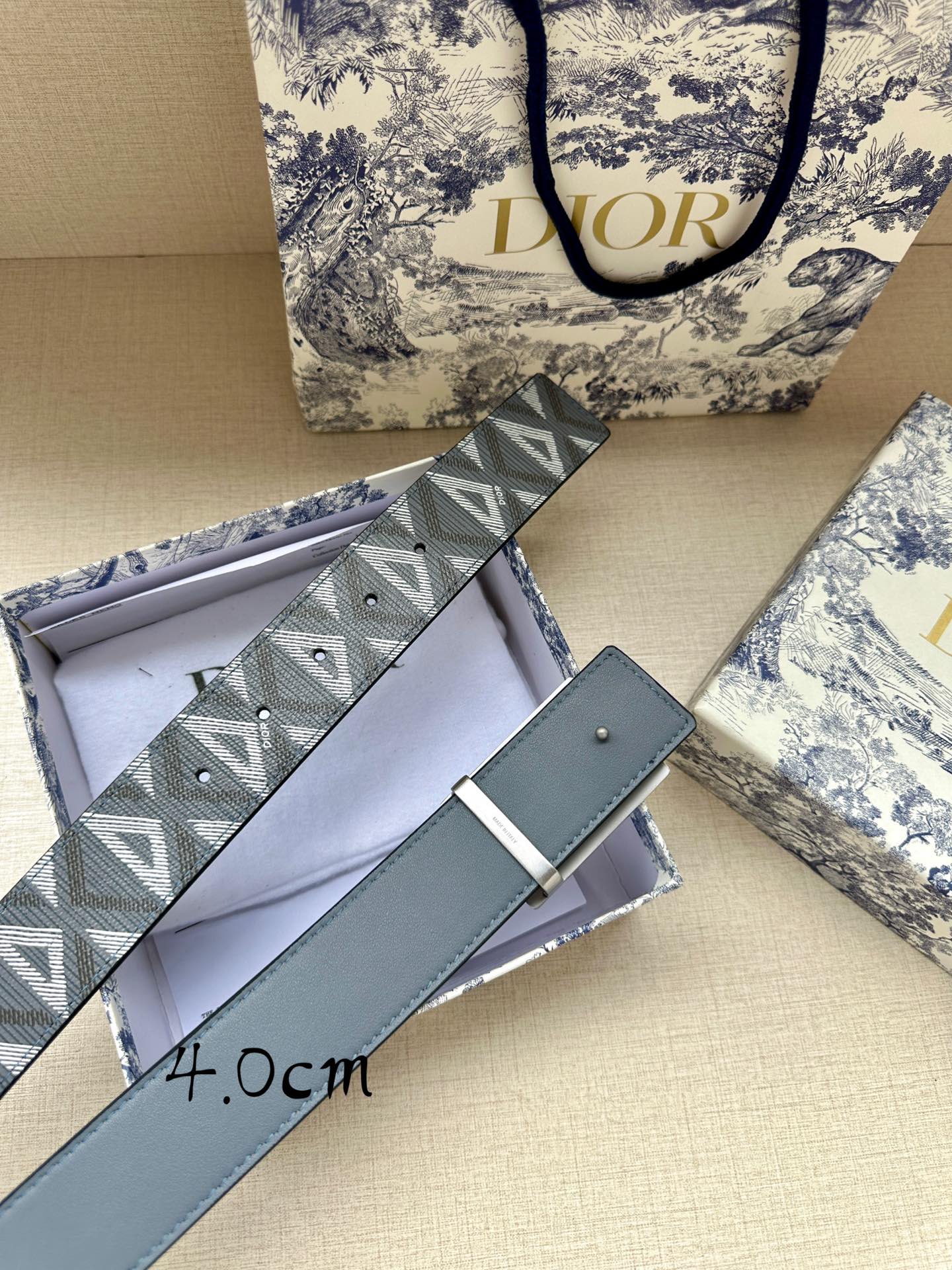 Dior belt with blue leather strap, gray jacquard logo panel, and silver-tone buckle