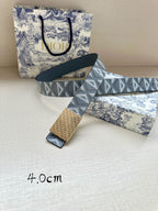 Dior belt with patterned strap and gold-tone buckle, laid flat with tag