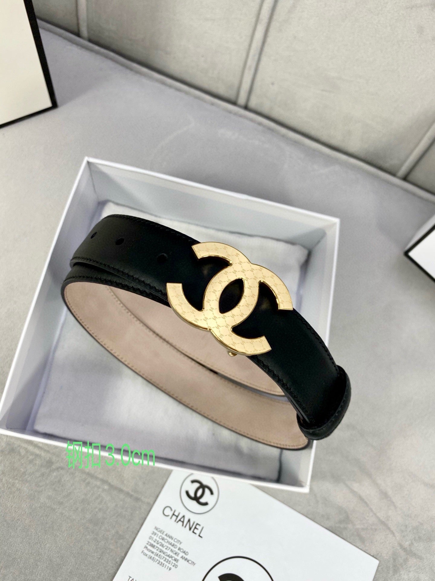 Black leather belt in box with gold-tone interlocking CC buckle