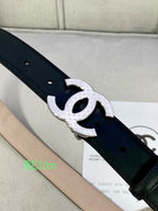 Black leather belt close-up with silver-tone interlocking CC buckle