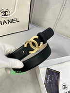 Black leather belt with gold-tone interlocking CC buckle, shown on display