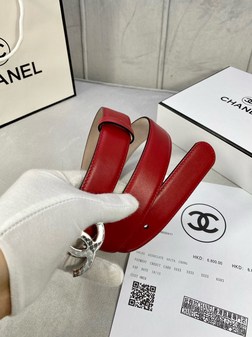 Chanel belt red leather with silver-tone double C buckle, front view.