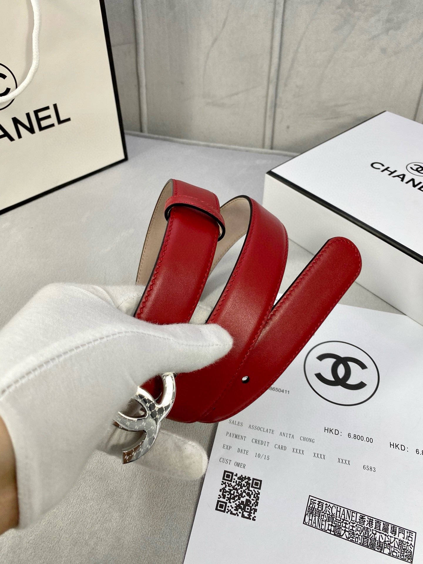 Chanel belt red leather with silver-tone double C buckle, front view.