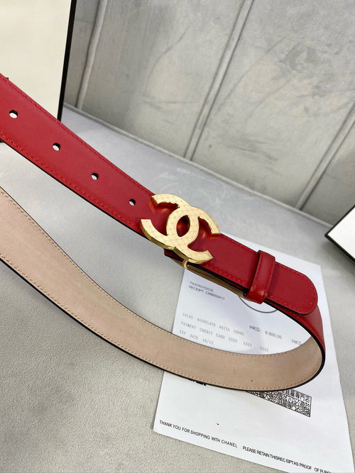 Chanel belt, red leather strap with gold-tone double C buckle and punched holes.