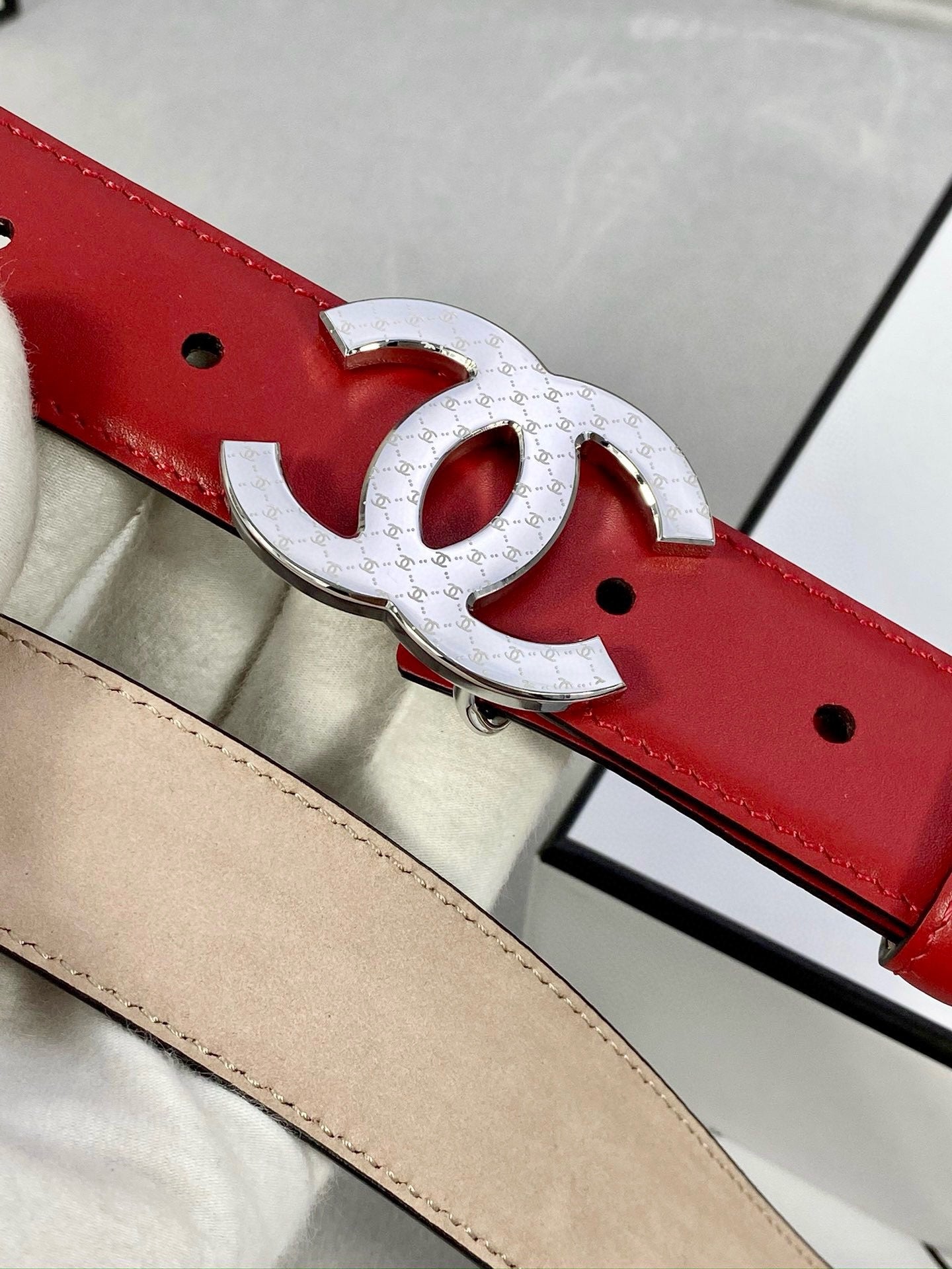 Chanel belt red leather with silver-tone double C buckle and metal eyelet holes.