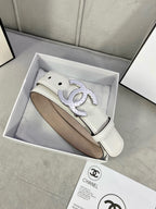 White leather Chanel belt with gold-tone CC buckle inside a gift box