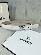 White leather Chanel belt with silver-toned CC buckle on display