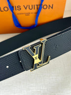 Textured dark blue belt with gold-tone LV buckle, close-up