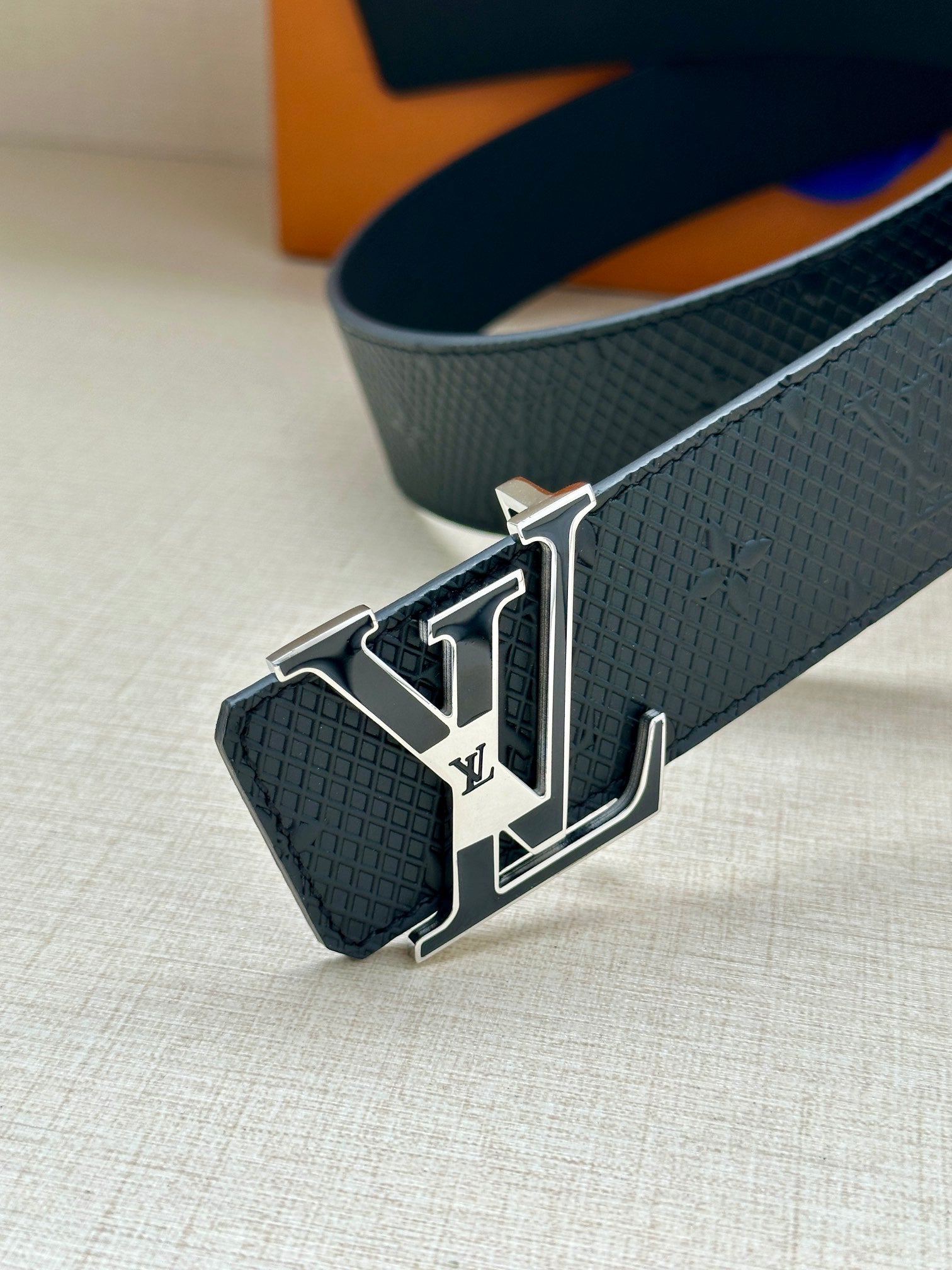 Textured dark blue belt with silver-tone LV buckle on the end
