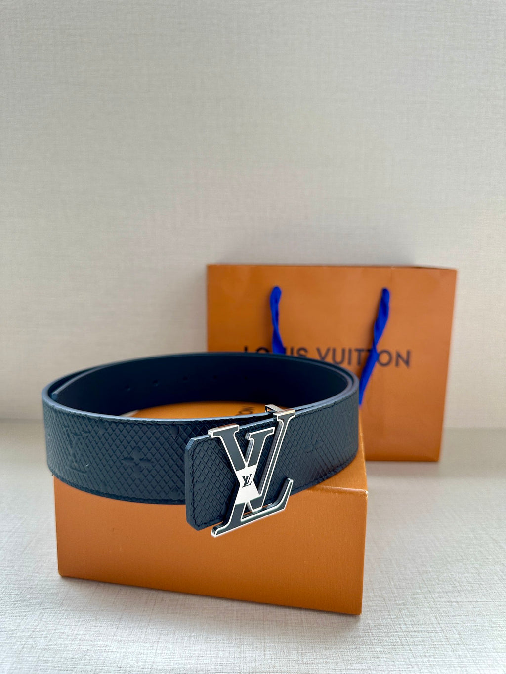 Textured dark blue leather belt with silver-tone LV buckle plate
