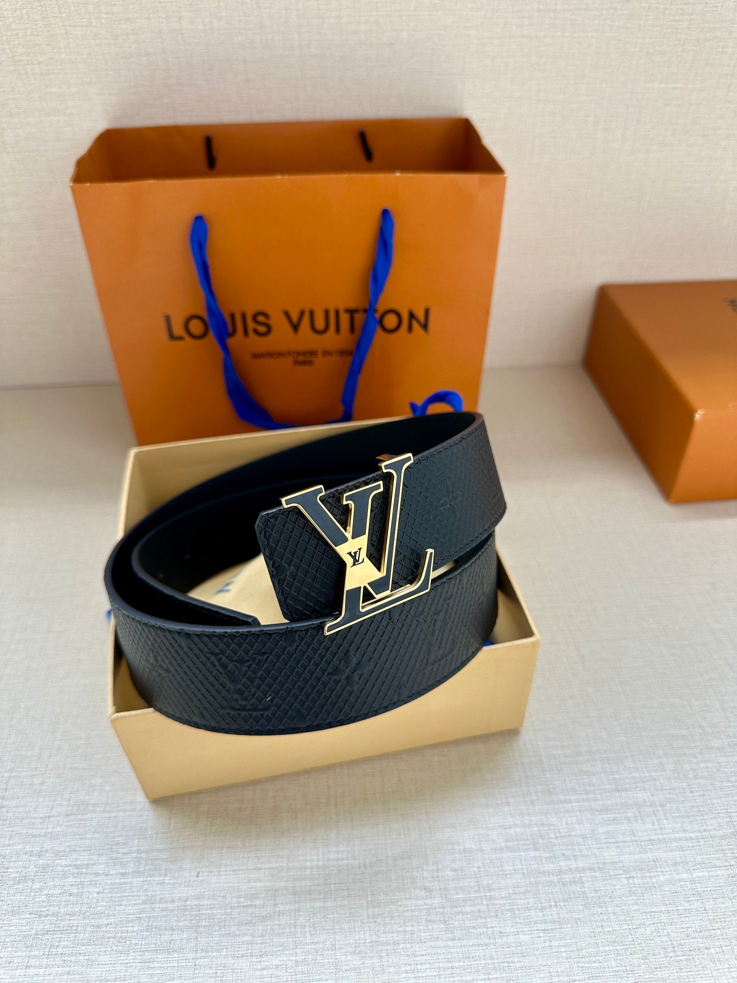 Textured dark blue leather belt with gold-tone LV buckle