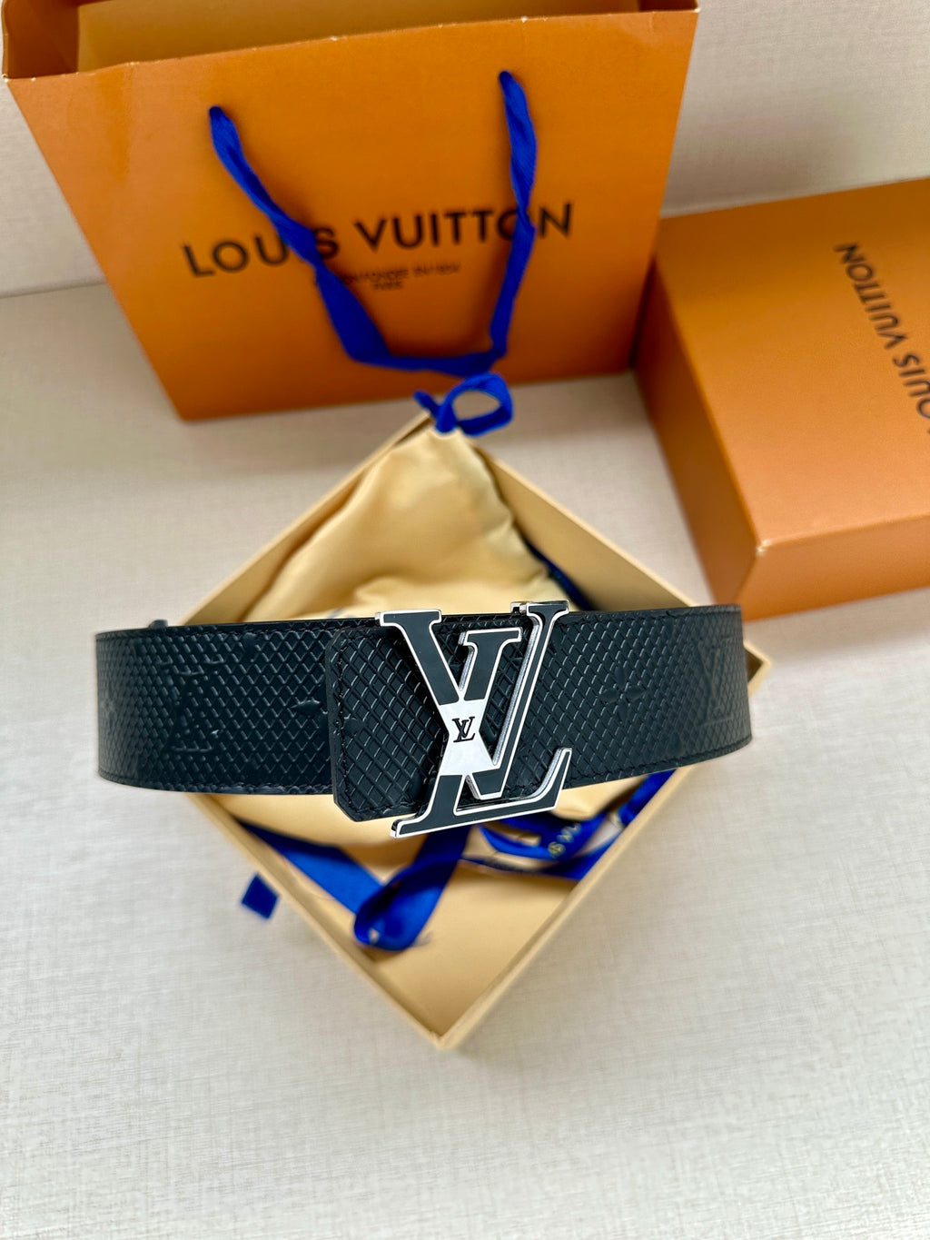 Textured dark blue leather belt with large LV buckle and blue keeper