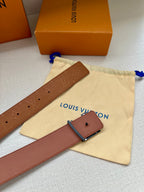 Tan Louis Vuitton belt with monogram texture, punched holes, and buckle