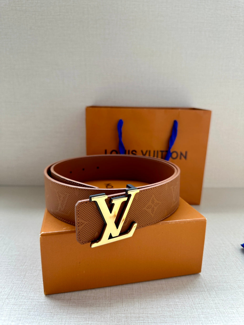 Brown Louis Vuitton belt with monogram texture and silver LV buckle