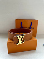 Brown Louis Vuitton belt with monogram texture and silver LV buckle