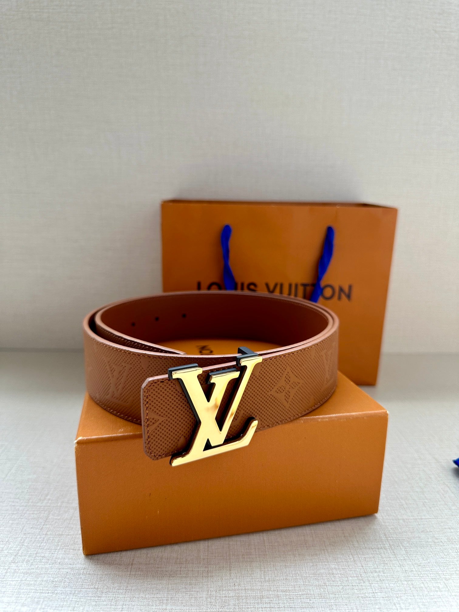 Brown Louis Vuitton belt with monogram texture and silver LV buckle