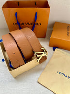 Light tan Louis Vuitton belt with monogram strap and silver LV buckle