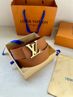 Light tan Louis Vuitton belt with monogram strap and silver LV buckle, angled