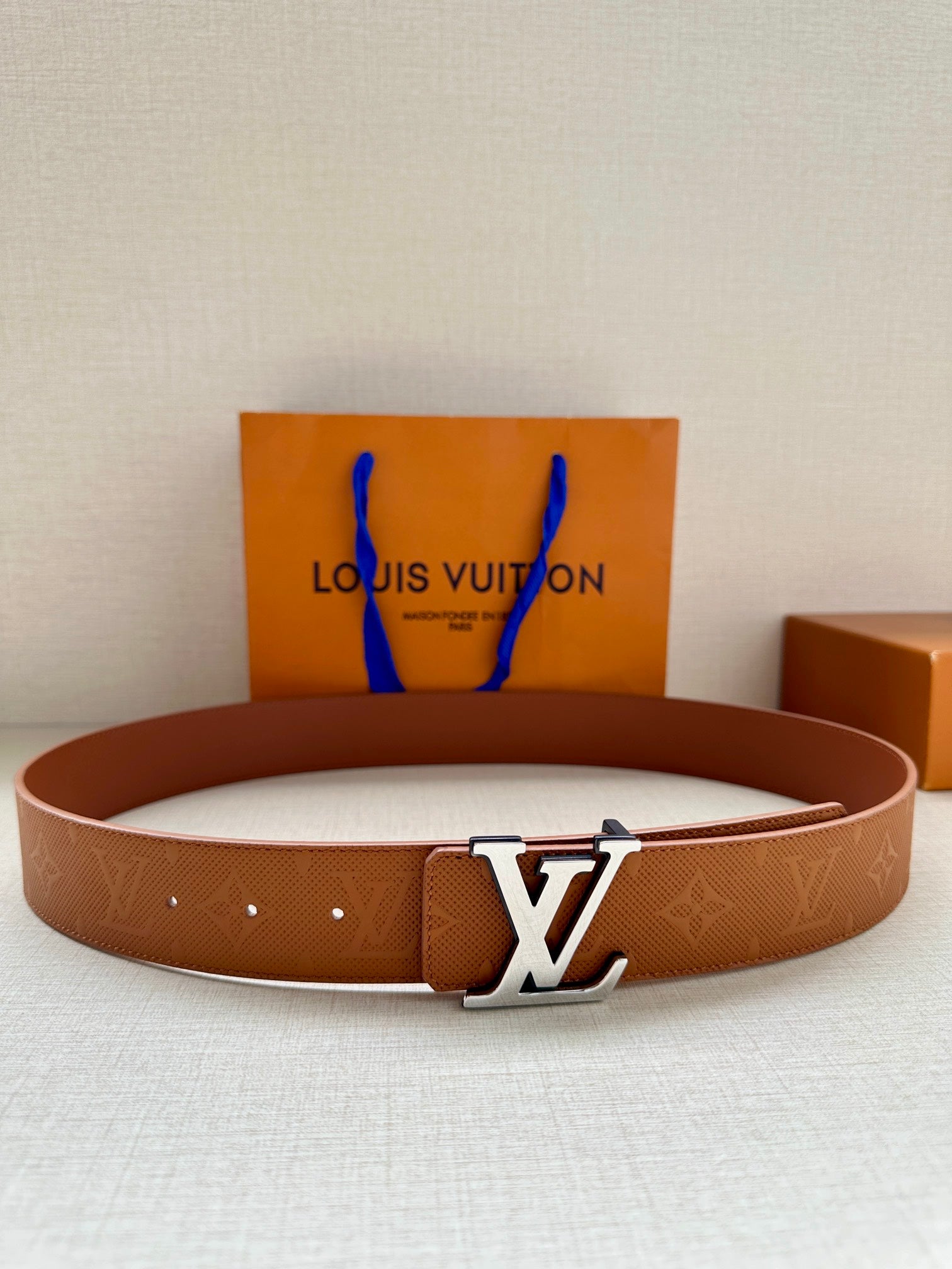Brown Louis Vuitton belt with monogram pattern and large LV buckle