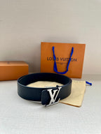 Louis Vuitton belt on beige pouch: dark navy leather strap with gold-tone LV buckle
