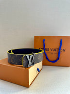 Louis Vuitton monogram belt with gold buckle, blue edge trim, angled view