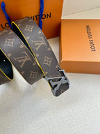 Louis Vuitton monogram belt buckle close-up with blue edge trim and gold hardware