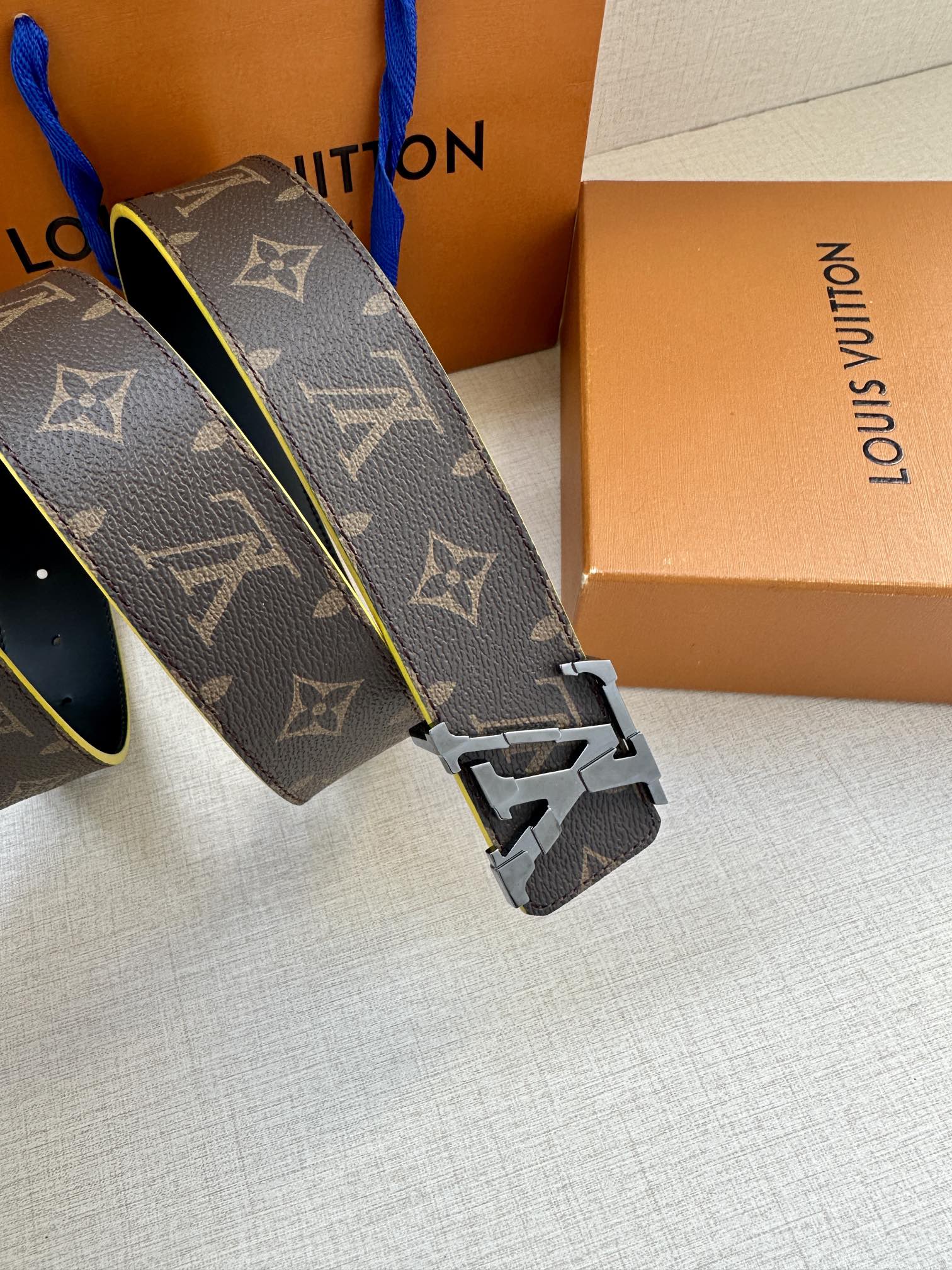 Louis Vuitton monogram belt buckle close-up with blue edge trim and gold hardware