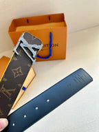Louis Vuitton monogram belt buckle close-up with blue edge trim and gold hardware