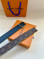 Louis Vuitton monogram belt with blue edge trim and gold buckle, unrolled
