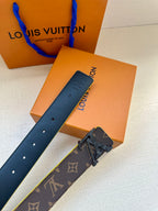 Louis Vuitton belt with monogram dark strap, stud holes, and gold buckle