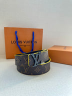 Louis Vuitton belt with monogram pattern, dark strap, gold buckle, and yellow trim