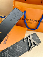 Leather belt strap close-up with monogram texture and silver-tone buckle