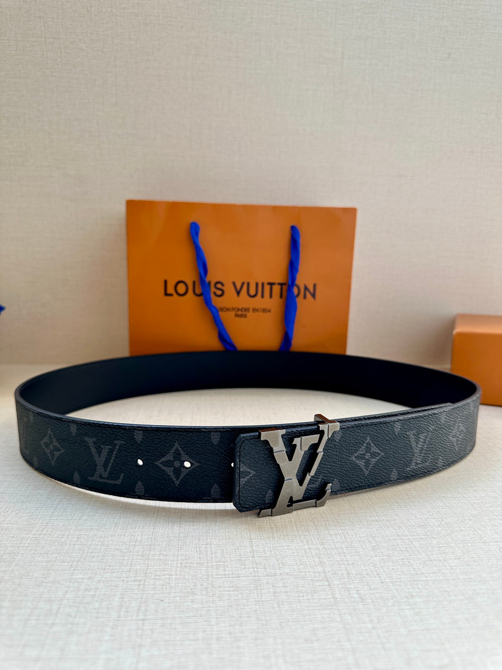 Dark monogram leather belt with silver-tone buckle and V cutout detail