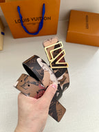 Designer belt with printed logo-style strap and oversized gold-tone LV buckle