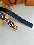Designer belt with patterned strap and gold-tone LV buckle, flat on surface