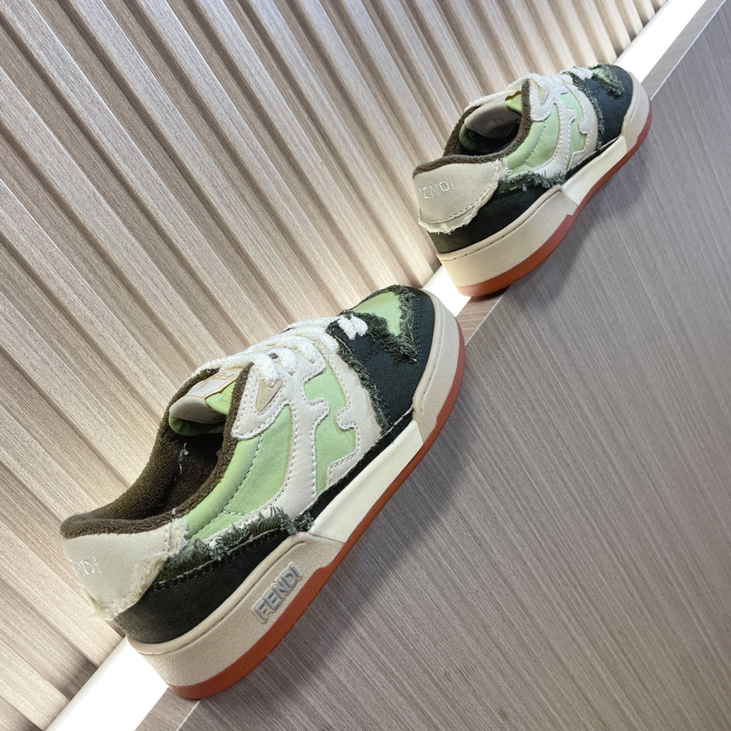 Fendi low-top sneakers, side view, white laces with lime green, black, and pinkish outsole edge.