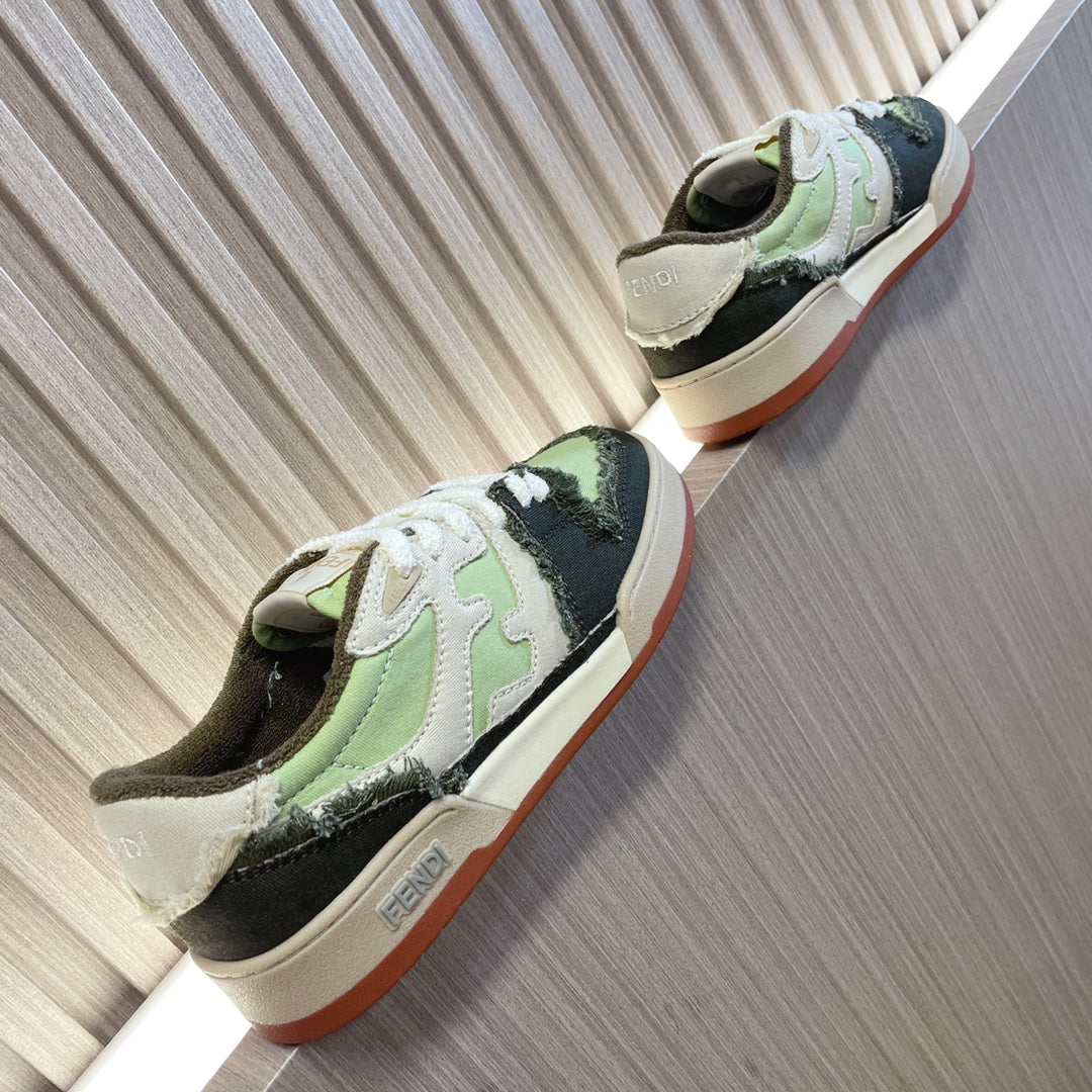 Fendi low-top sneakers, side view, white laces with lime green, black, and pinkish outsole edge.